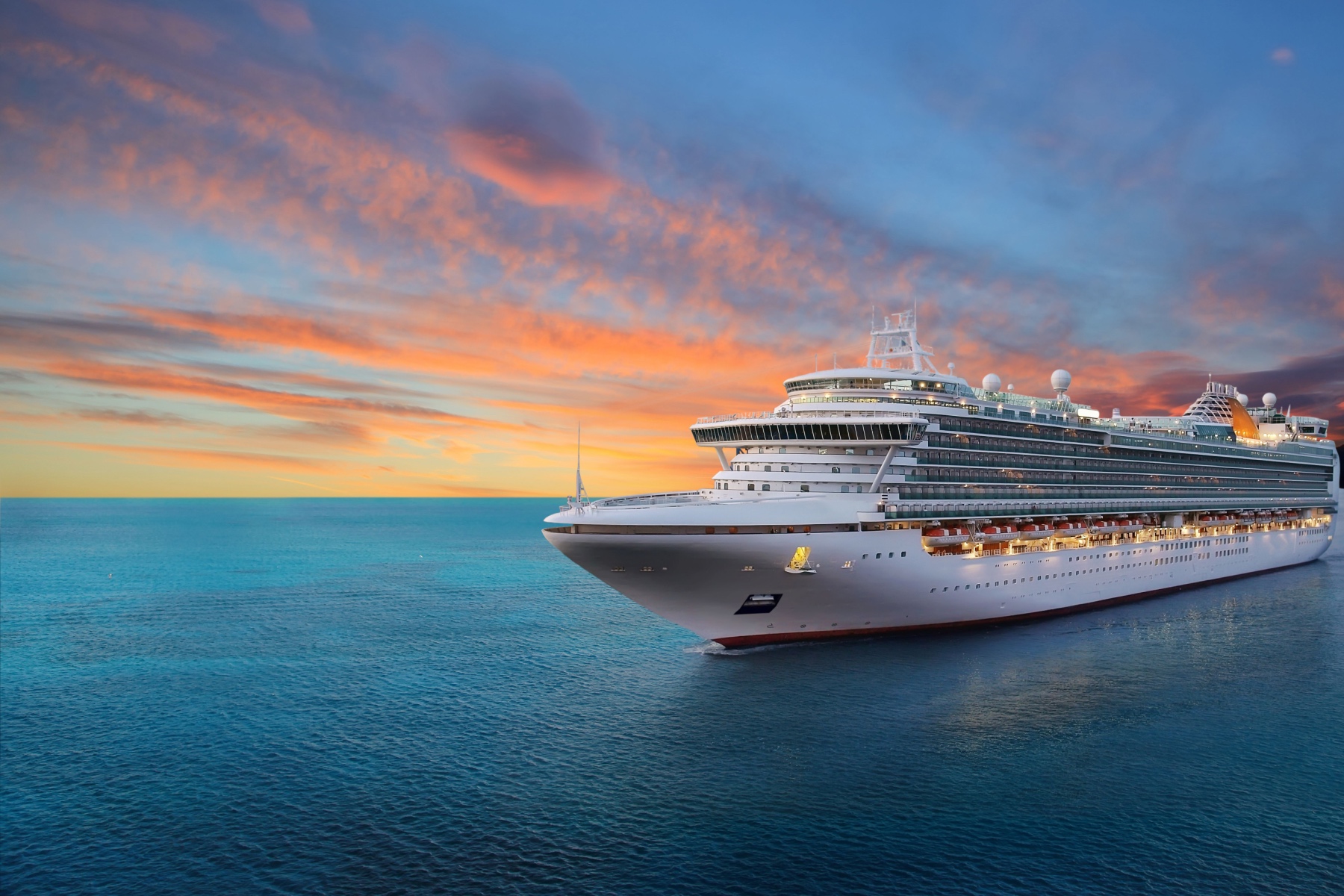 Luxury cruise ship at sea during sunset with Virtuoso style